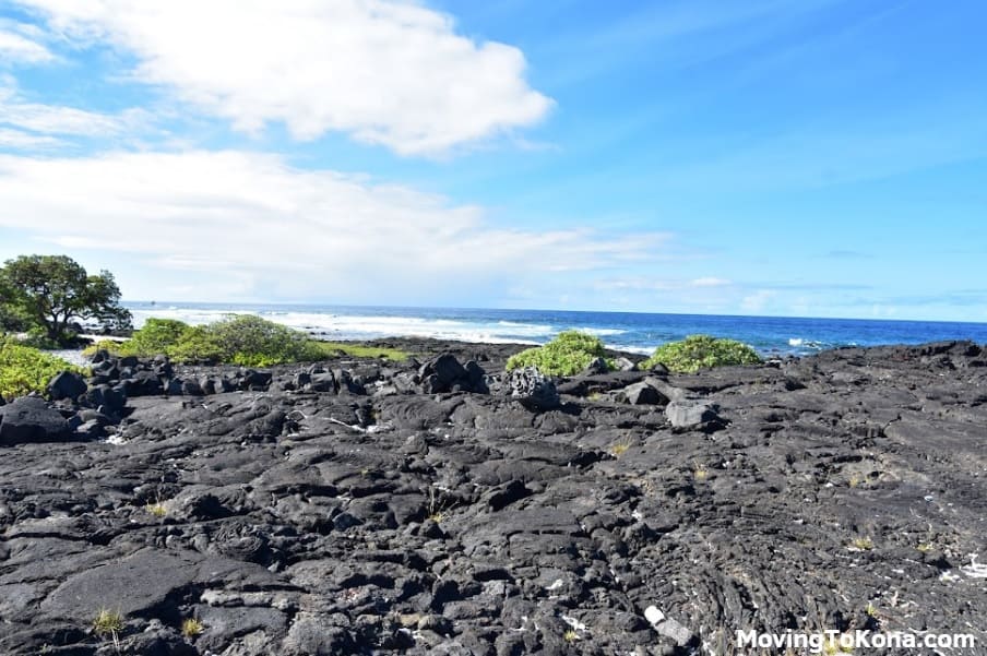 Hawaiian coastline with lava rocks.
